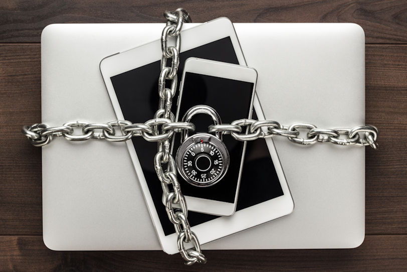 A computer, tablet, and phone locked together.