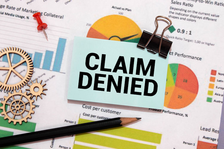 A financial spreadsheet with a "Claim Denied" note on top.